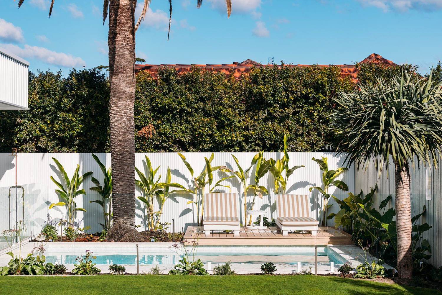 Poolside lounge setting and landscaping beside a Newcastle backyard pool